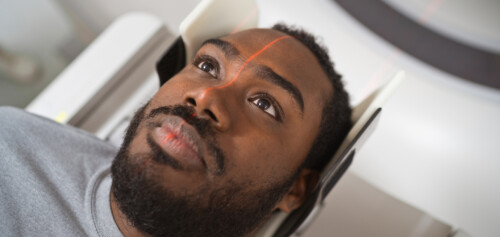 Male patient undergoing MRI scan in medical examination room